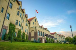 Exterior of large signature resort with Canadian flag on roof