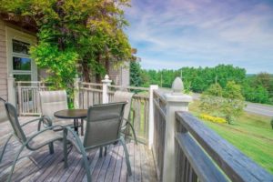 Outdoor wooden patio with table and chairs